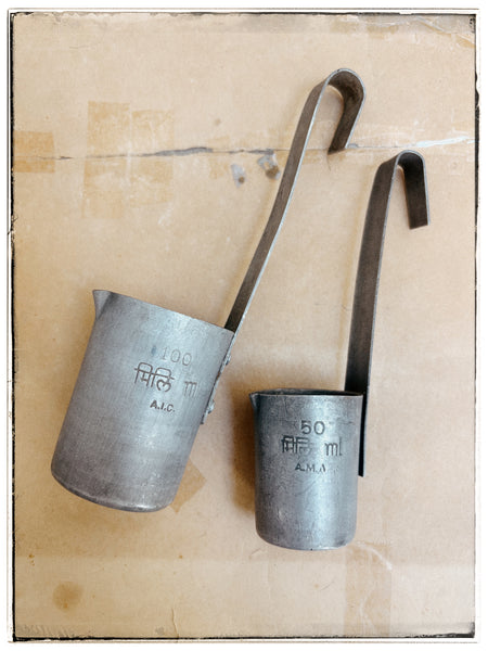 Vintage tin milk measures