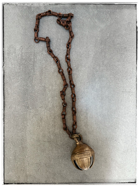 Antique brass bell on chain