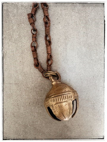 Antique brass bell on chain
